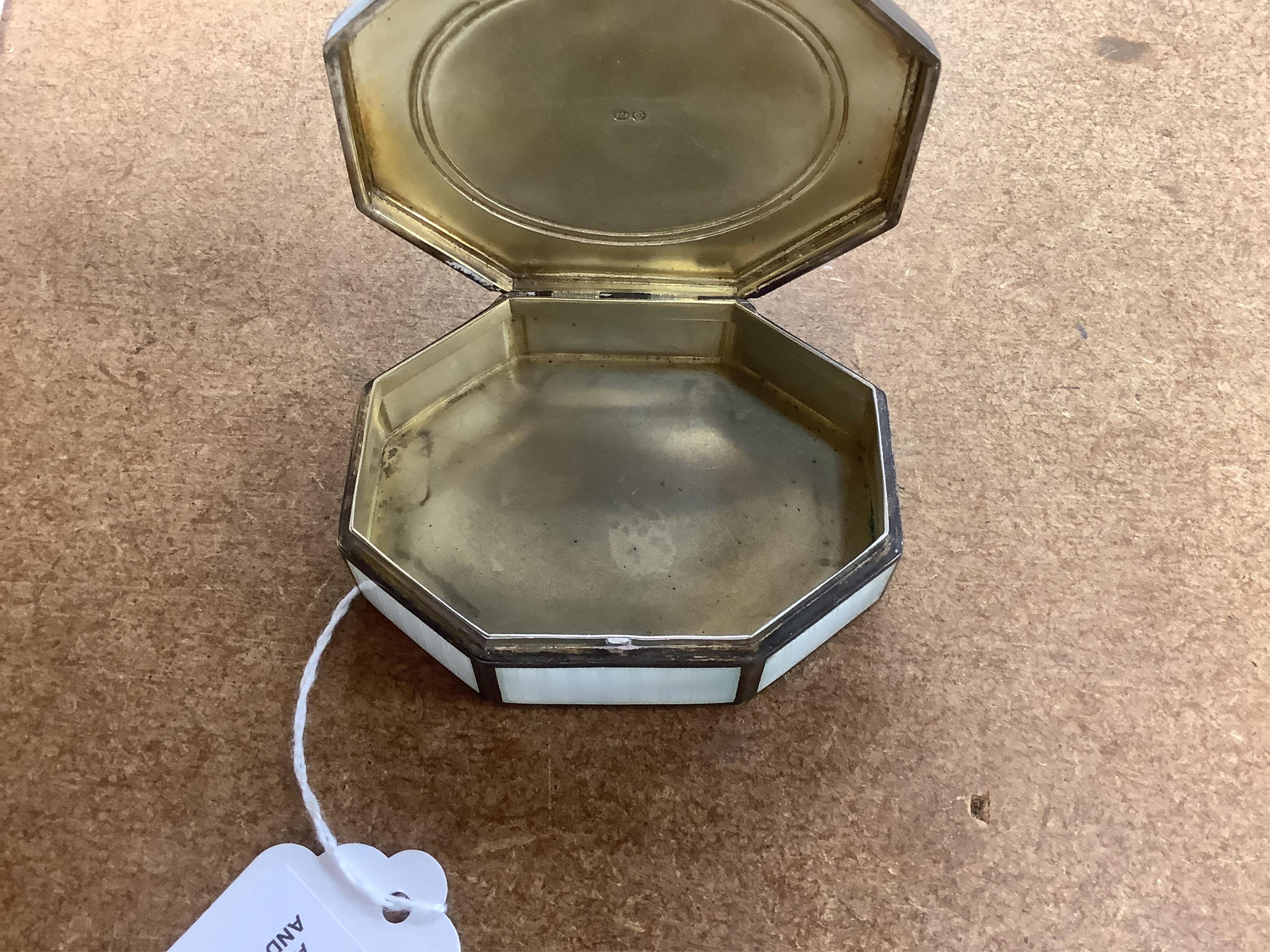 An Edwardian silver and guilloche enamel octagonal box with hinged cover, import marks for Erich Kellerman, London, 1909, decorated with flowers and musical instruments, 77mm.